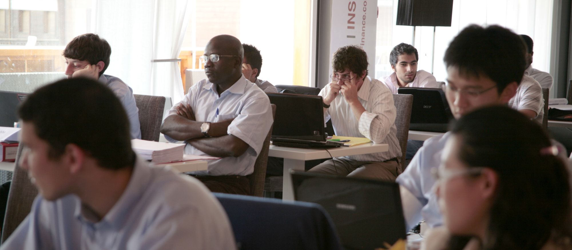 Students at laptops in a mentoring session